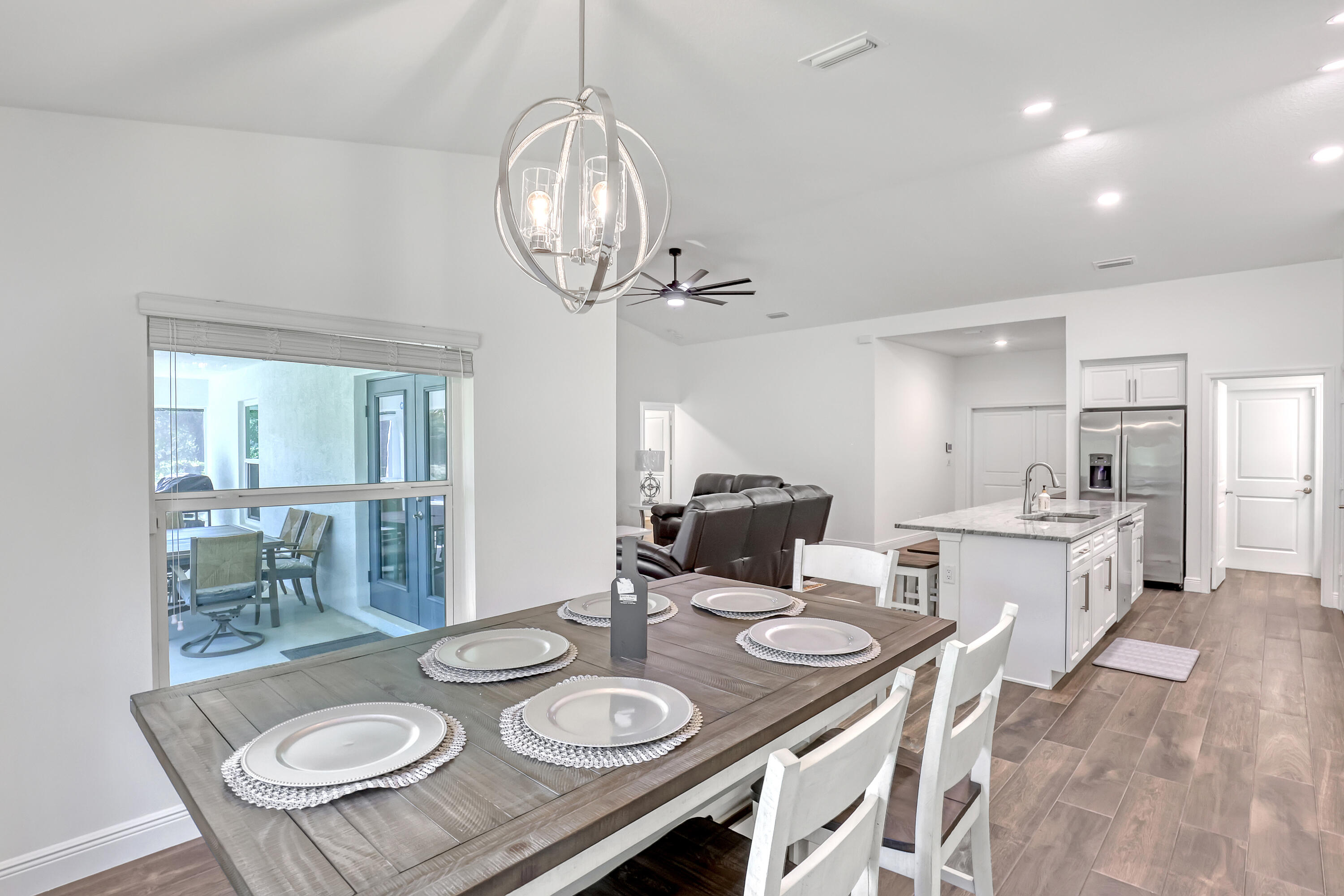 16775 Orange Boulevard Loxahatchee, FL 33470 - Photo 16 of 53 a view of a dining room with furniture wooden floor and chandelier