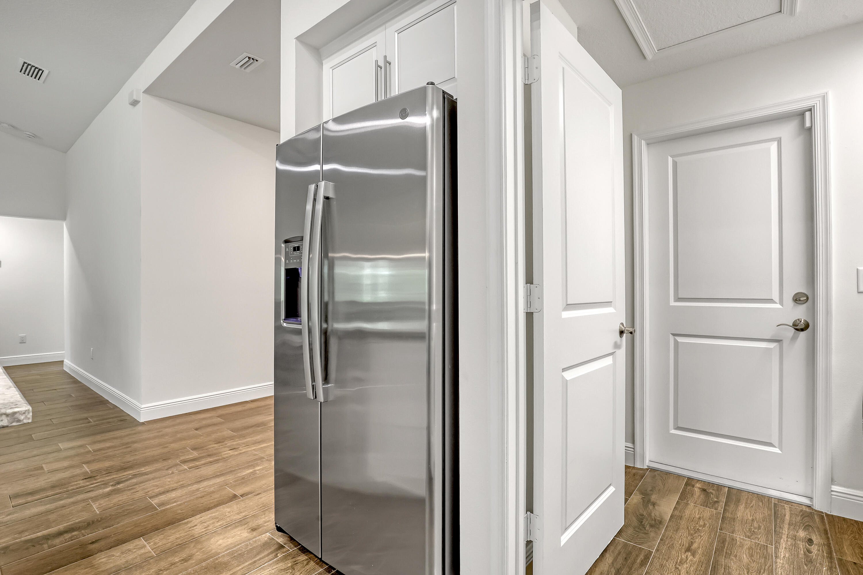 16775 Orange Boulevard Loxahatchee, FL 33470 - Photo 17 of 53 a bathroom with a glass shower door and a wooden floor