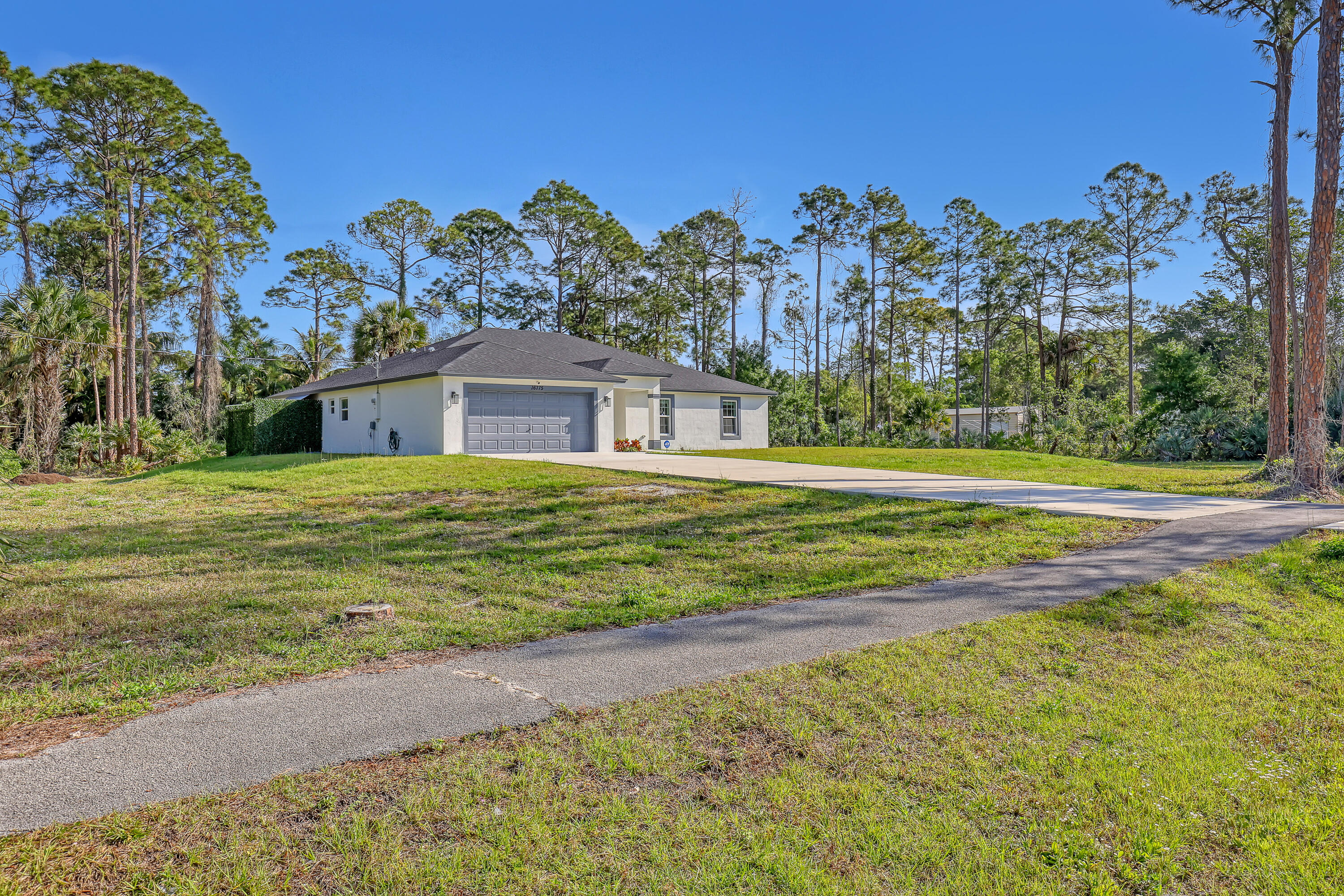 16775 Orange Boulevard Loxahatchee, FL 33470 - Photo 2 of 53 a view of a house with a big yard