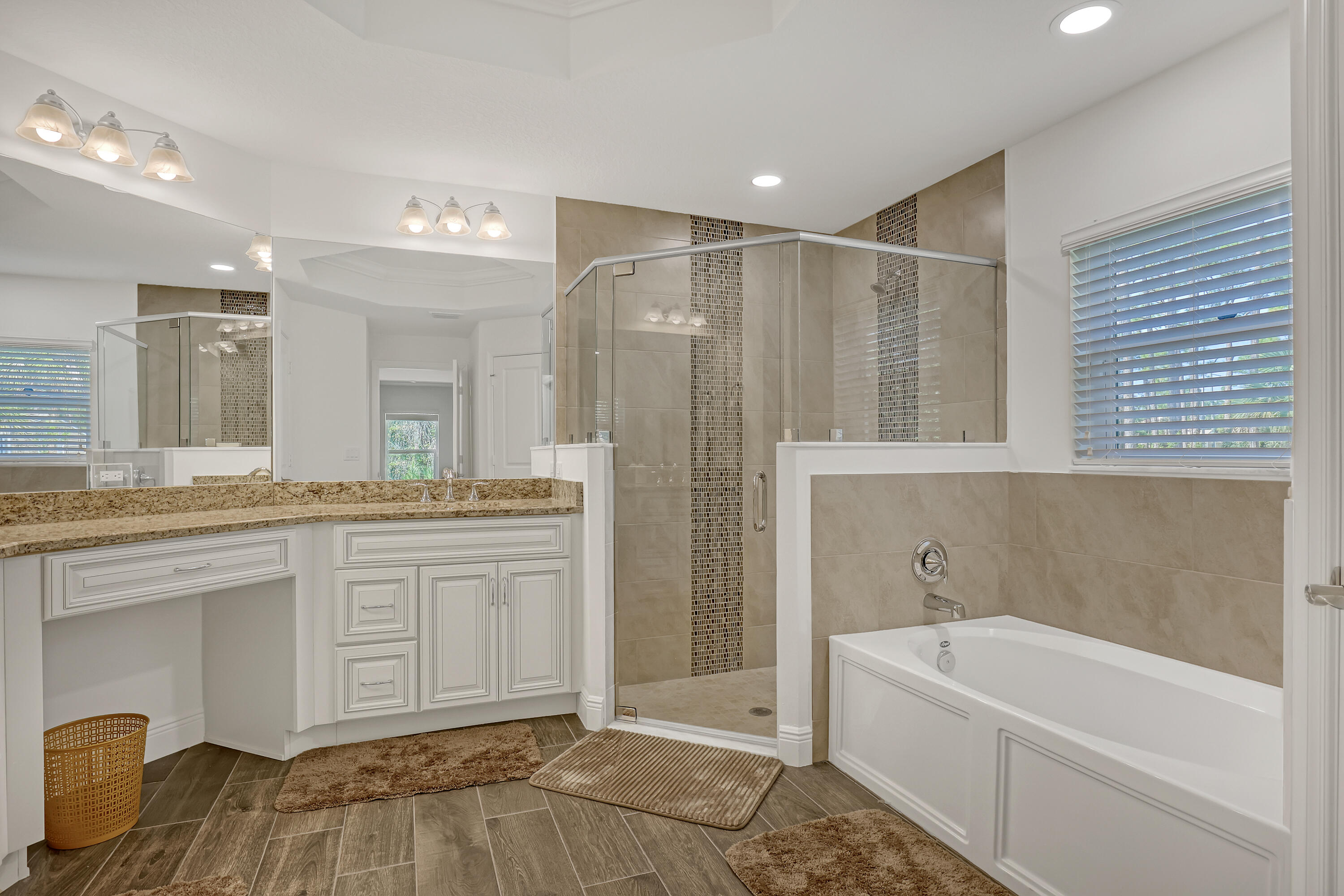 16775 Orange Boulevard Loxahatchee, FL 33470 - Photo 22 of 53 a bathroom with a tub a sink and mirrors