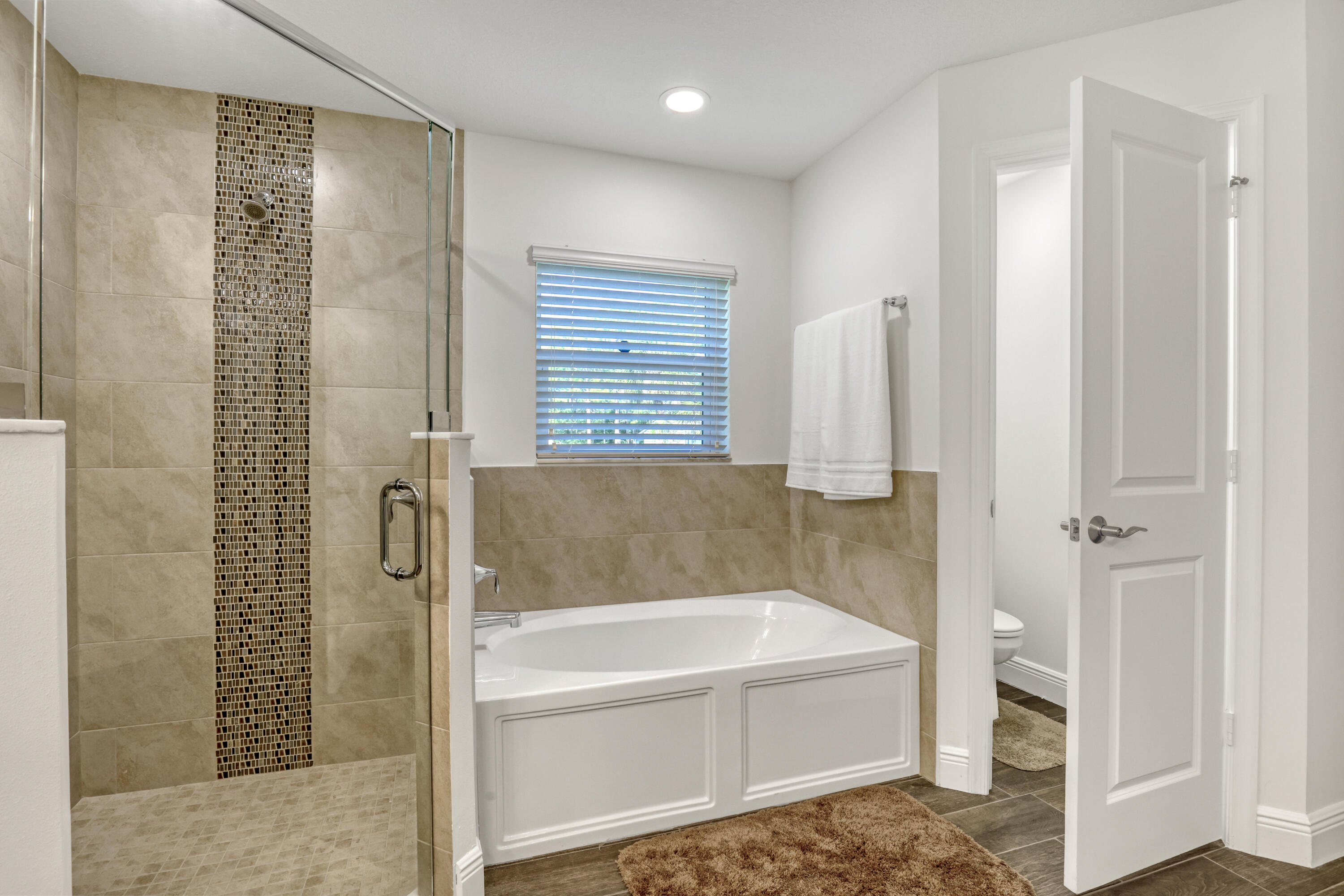16775 Orange Boulevard Loxahatchee, FL 33470 - Photo 23 of 53 a bathroom with a bathtub and a shower