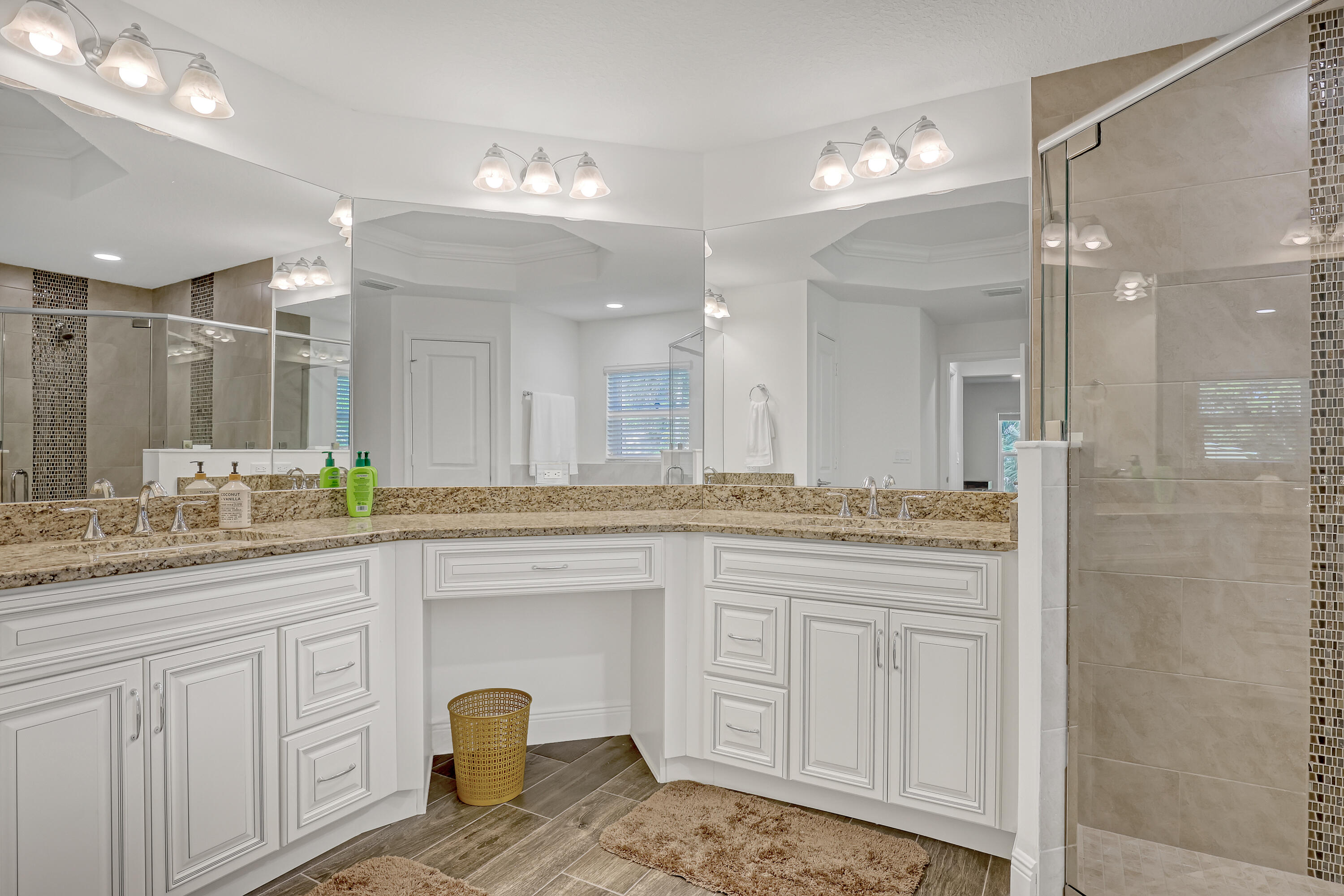 16775 Orange Boulevard Loxahatchee, FL 33470 - Photo 24 of 53 a bathroom with a granite countertop sink a large mirror and shower