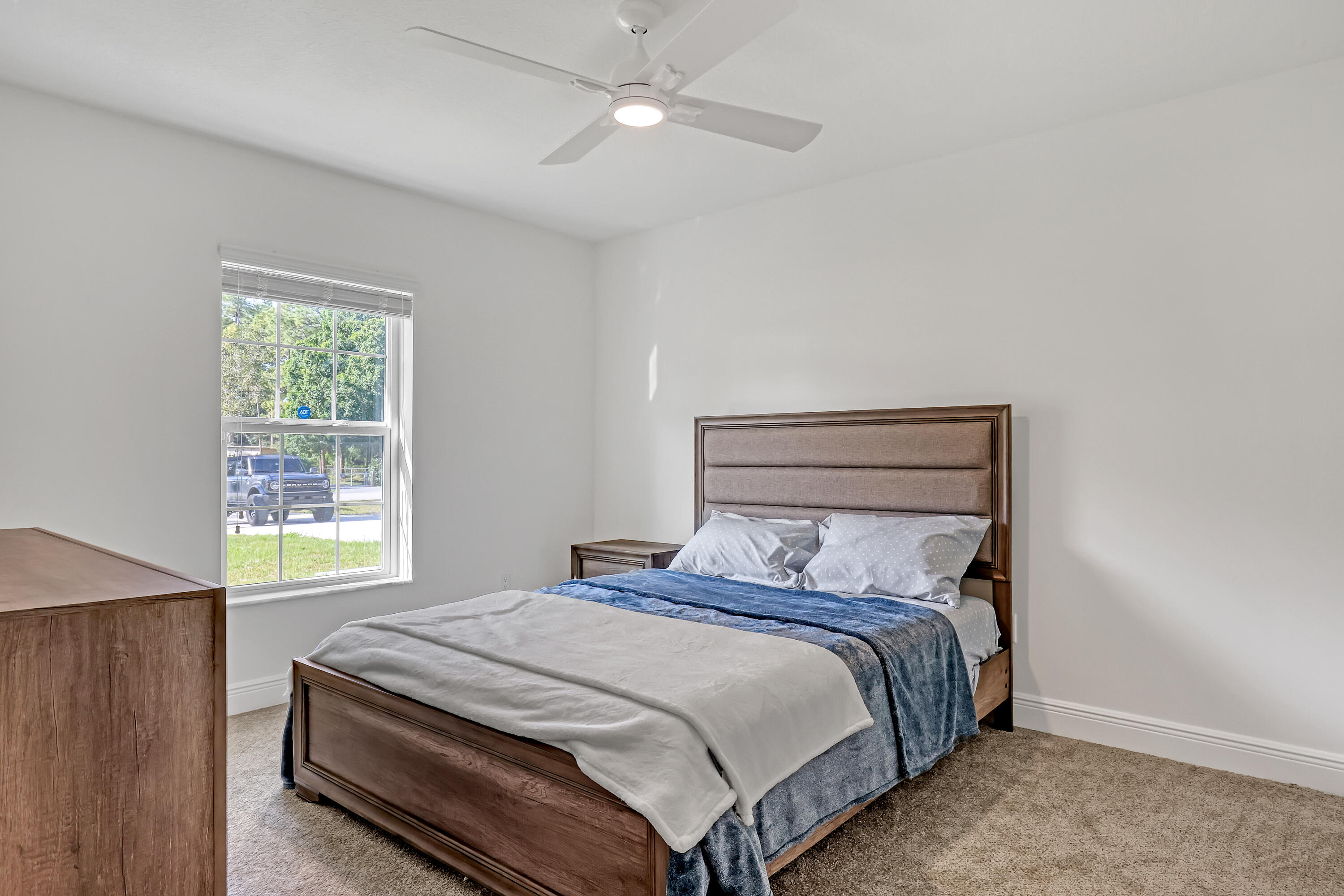 16775 Orange Boulevard Loxahatchee, FL 33470 - Photo 29 of 53 a bedroom with a bed and a window