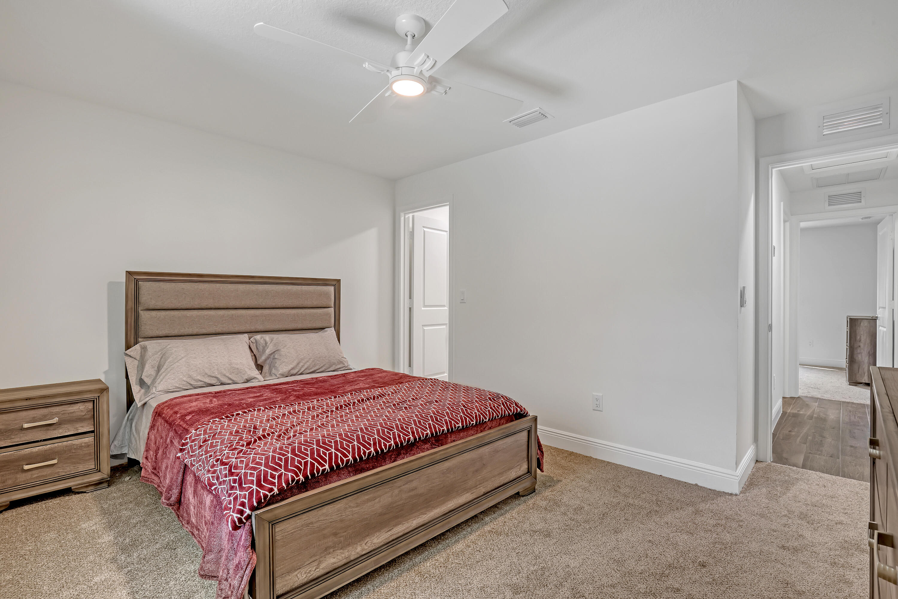 16775 Orange Boulevard Loxahatchee, FL 33470 - Photo 34 of 53 a bedroom with a bed and a chandelier