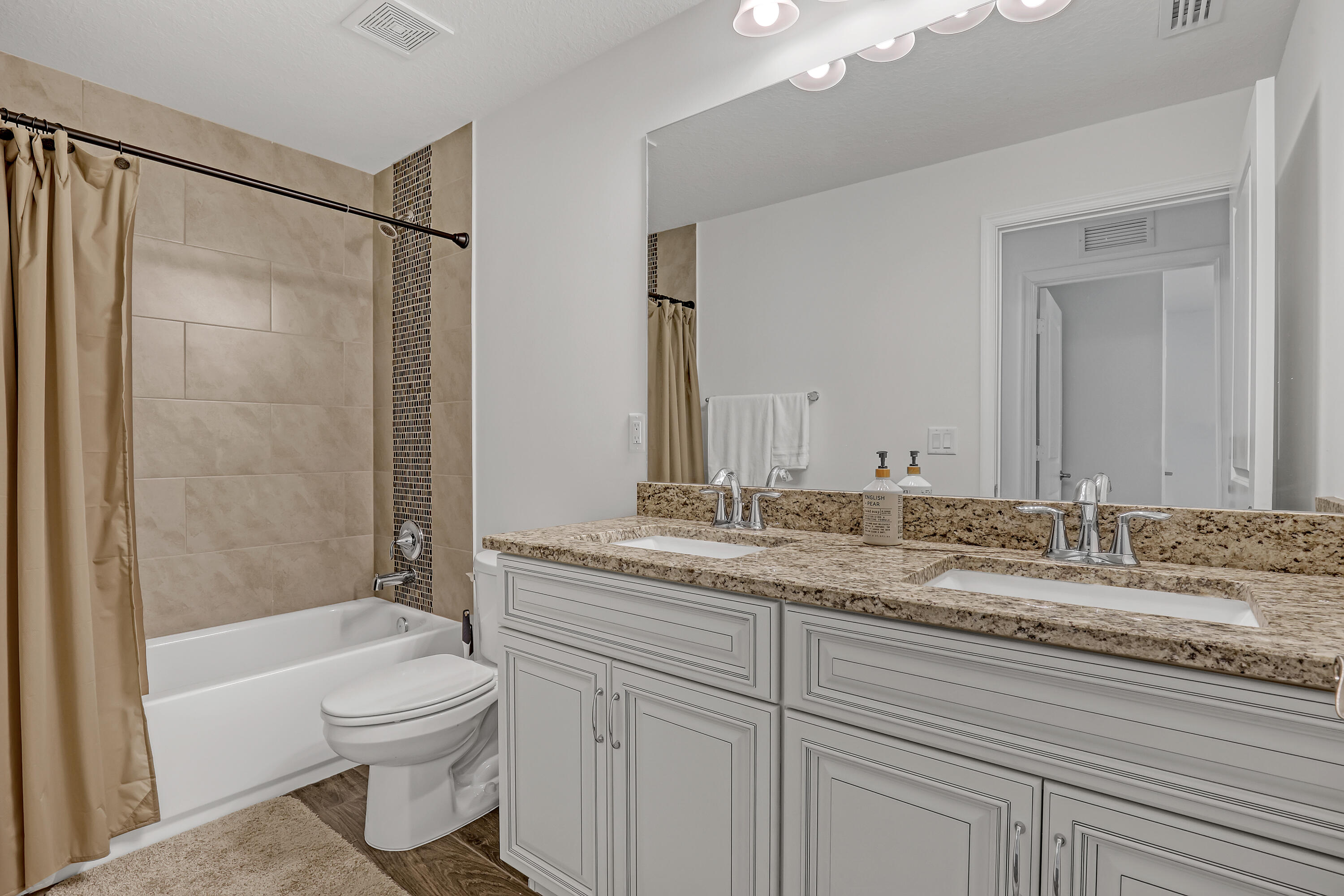 16775 Orange Boulevard Loxahatchee, FL 33470 - Photo 36 of 53 a bathroom with a granite countertop sink toilet and shower