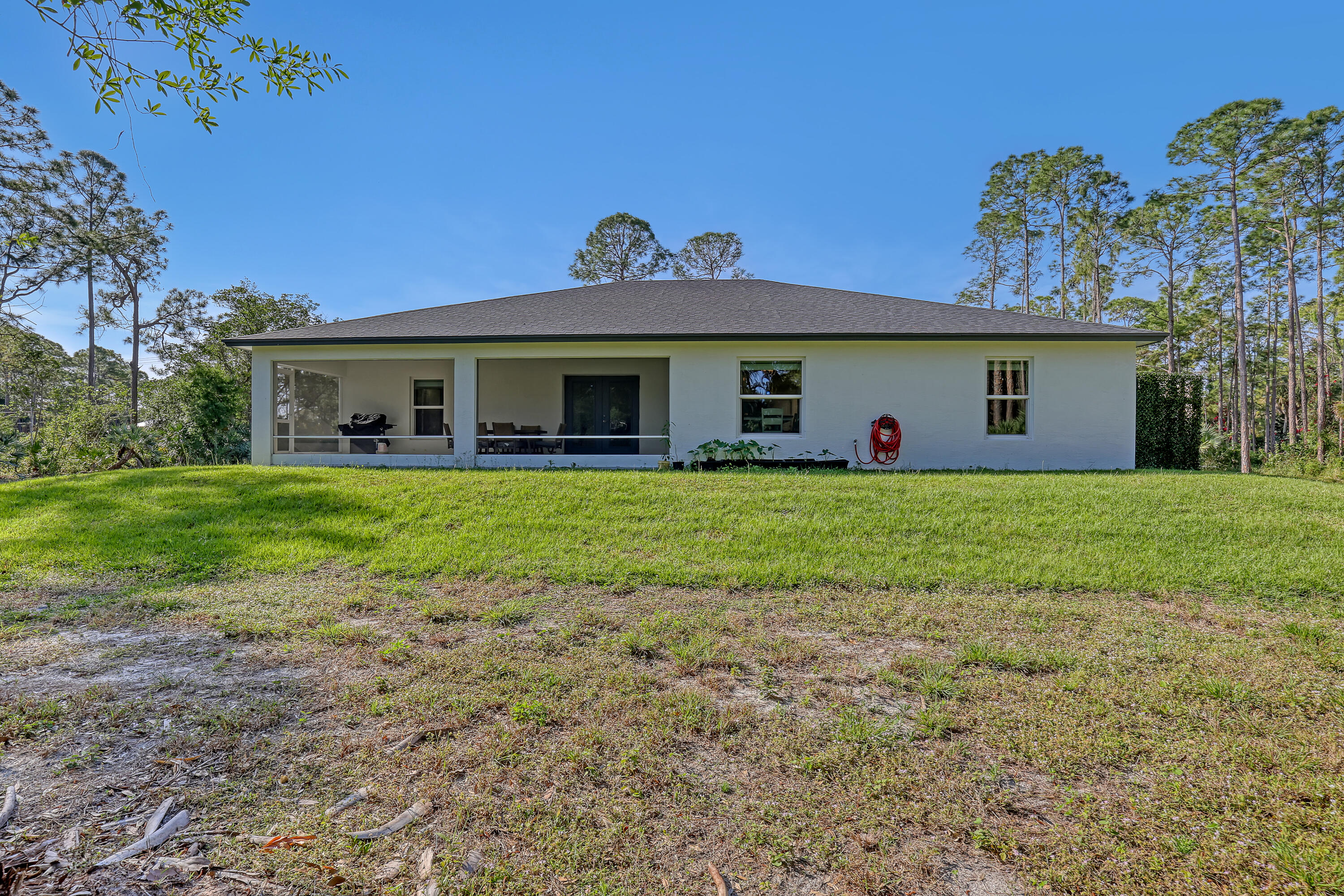 16775 Orange Boulevard Loxahatchee, FL 33470 - Photo 43 of 53 a view of a house with a yard and potted plants