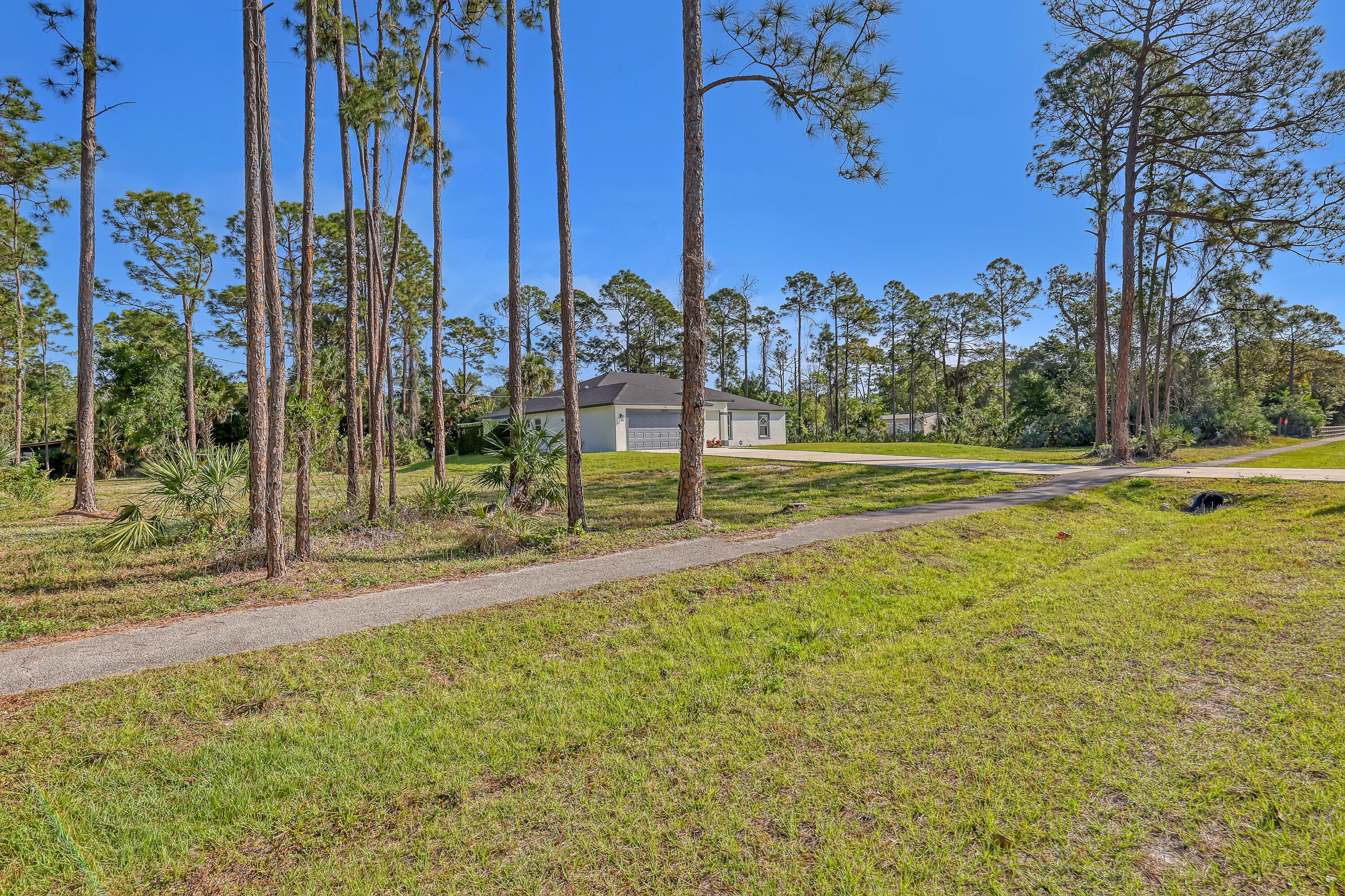 16775 Orange Boulevard Loxahatchee, FL 33470 - Photo 50 of 53 a view of a garden with a building in the background