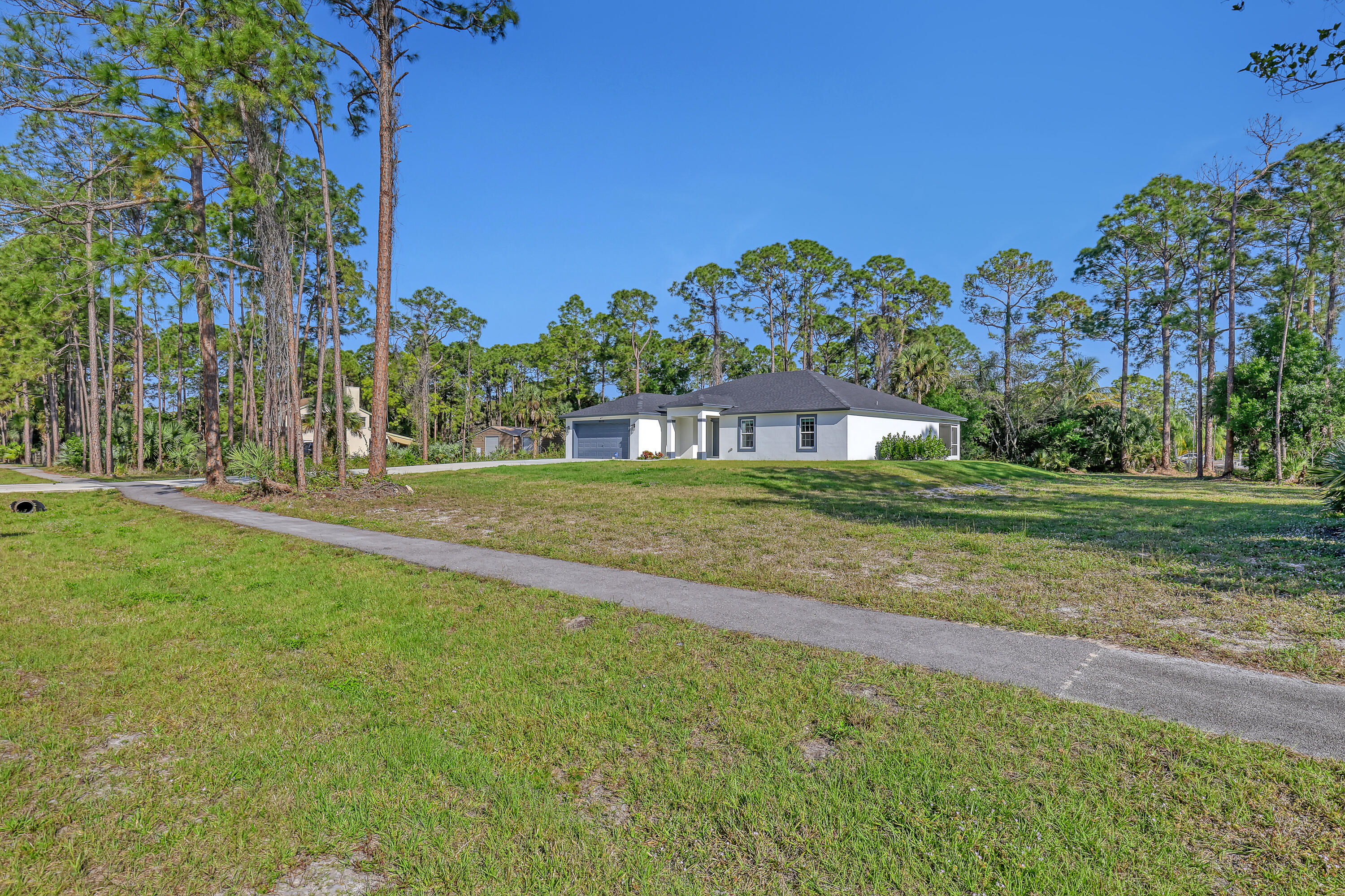16775 Orange Boulevard Loxahatchee, FL 33470 - Photo 52 of 53 a view of a house with a big yard