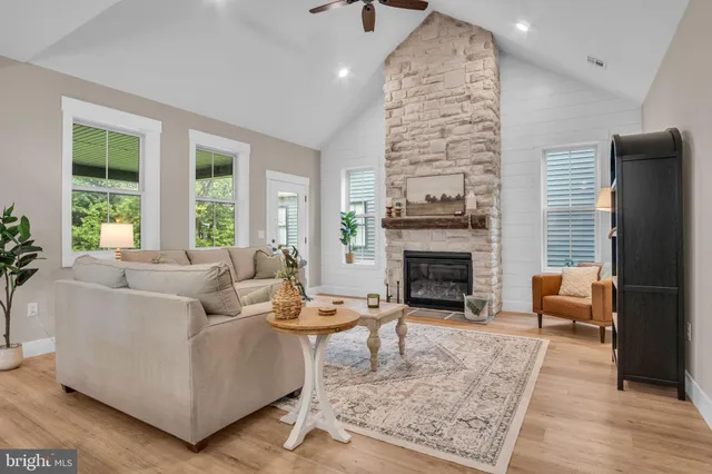 a living room with furniture and a fireplace