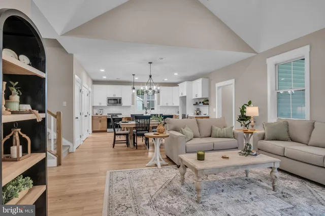a living room with furniture and view of kitchen