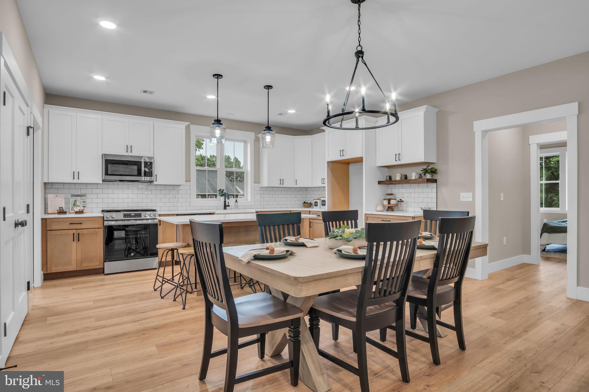 4120 Locust Road Camp Hill, PA 17011 - Photo 17 of 38 a view of a dining room and livingroom with furniture wooden floor a chandelier
