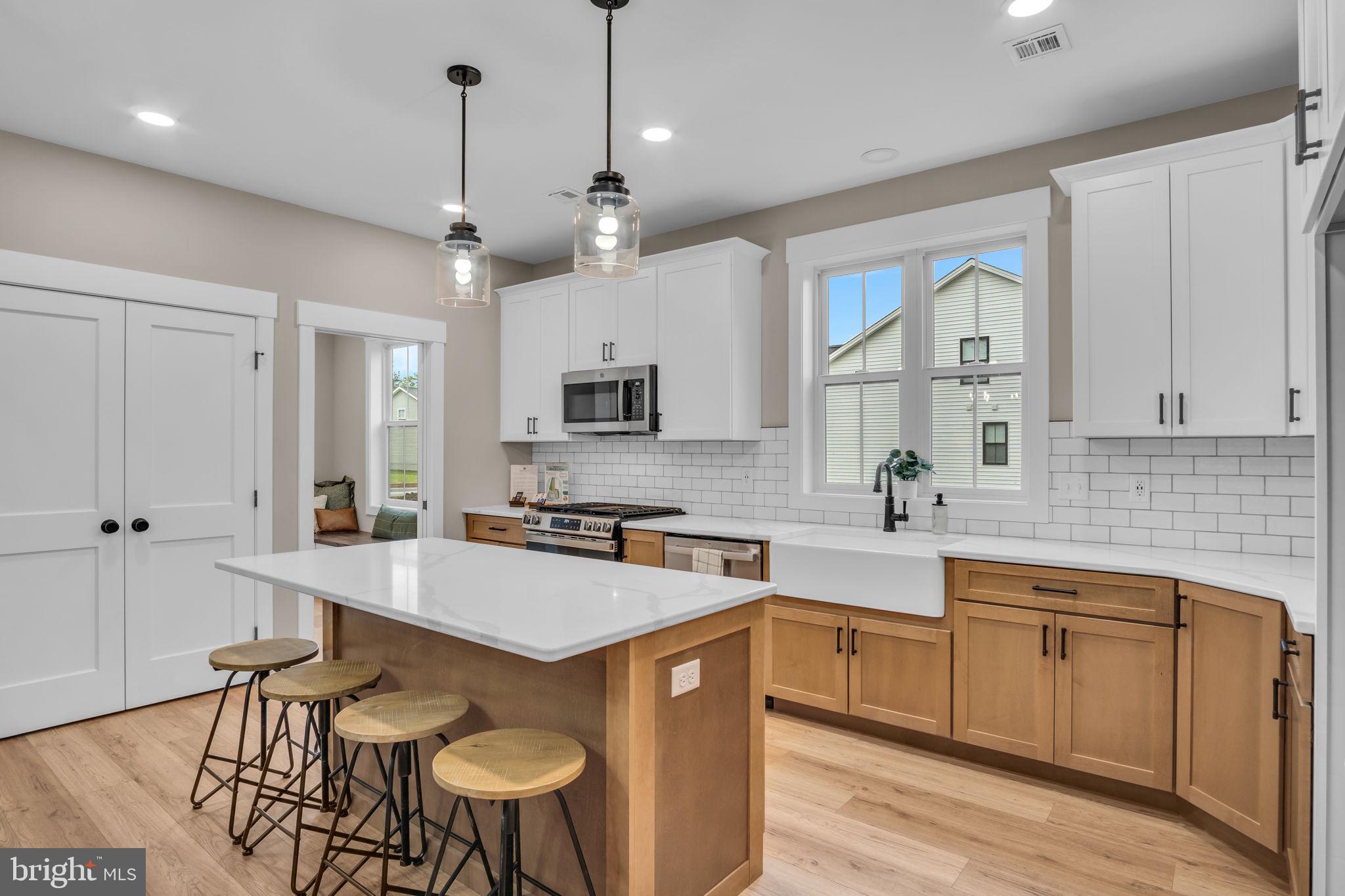4120 Locust Road Camp Hill, PA 17011 - Photo 19 of 38 a kitchen with stainless steel appliances granite countertop a sink a stove a refrigerator cabinets and chairs