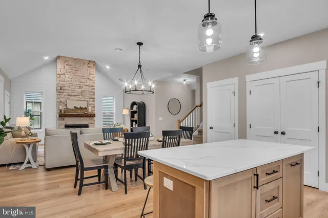 a kitchen with a table chairs and white cabinets
