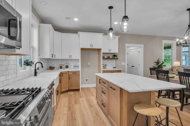 a kitchen with a stove a refrigerator and a dining table