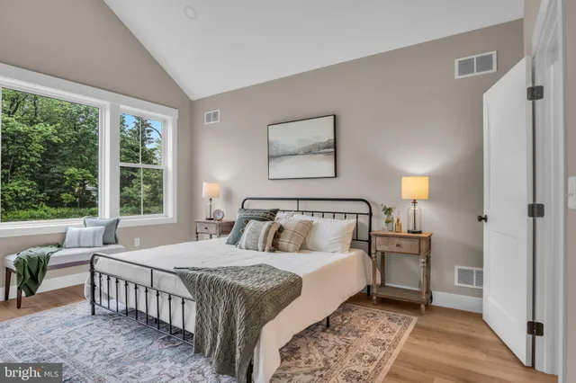 a bed room with a bed and a large window