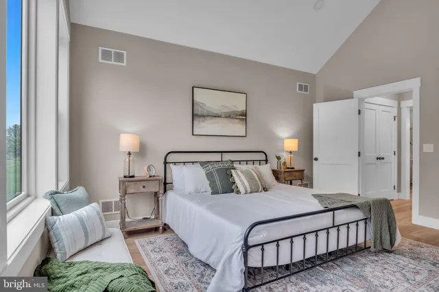 a spacious bedroom with a bed and a couch