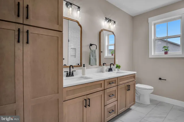 a bathroom with a double vanity sink and a mirror