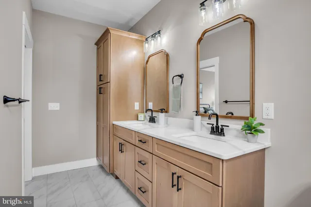 a bathroom with a double vanity sink and a mirror