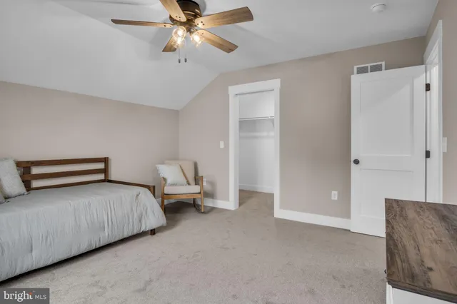 a bedroom with bed and window