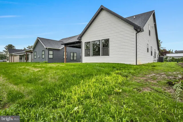 a view of a house with a yard and sitting area