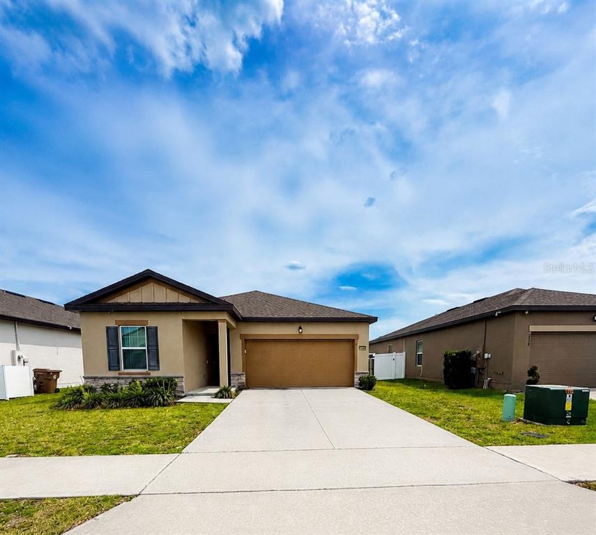 a front view of a house with a yard and garage