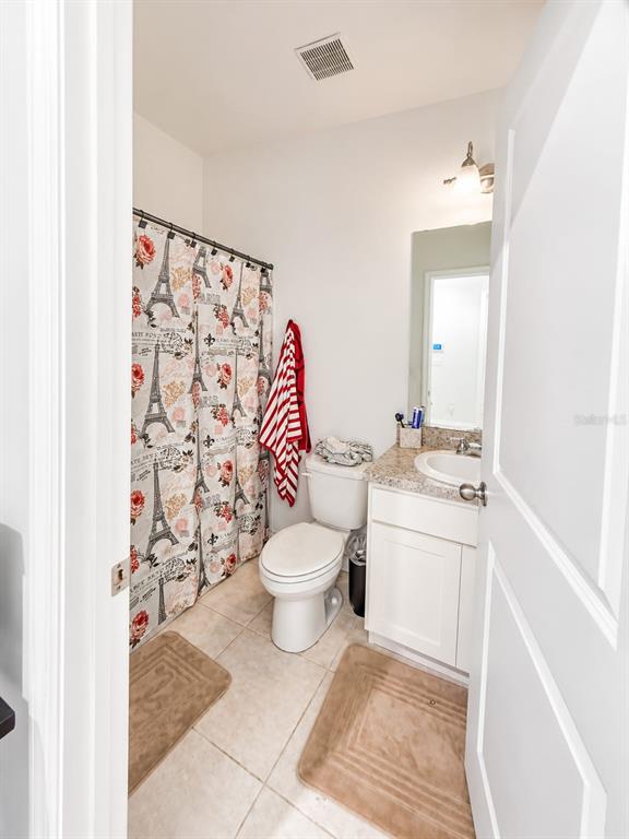 5882 Herder Road St. Cloud, FL 34771 - Photo 11 of 14 a bathroom with a toilet sink and mirror