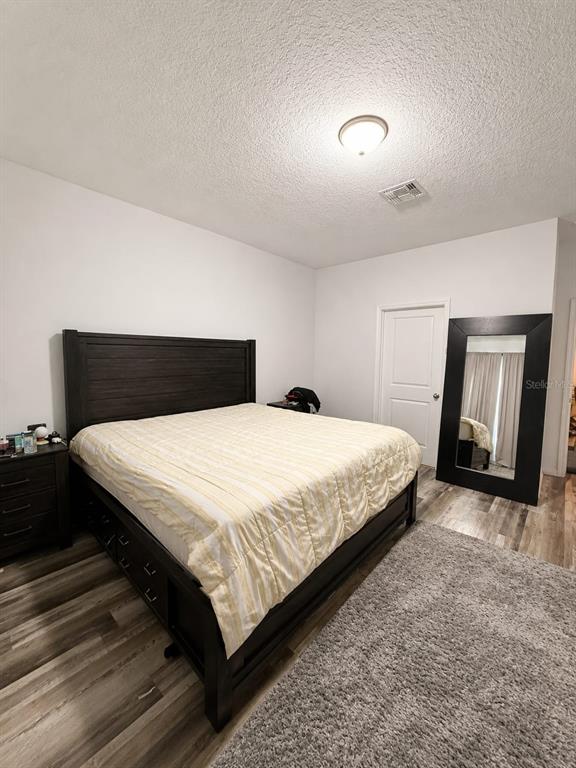 5882 Herder Road St. Cloud, FL 34771 - Photo 6 of 14 a bedroom with a bed and mirror