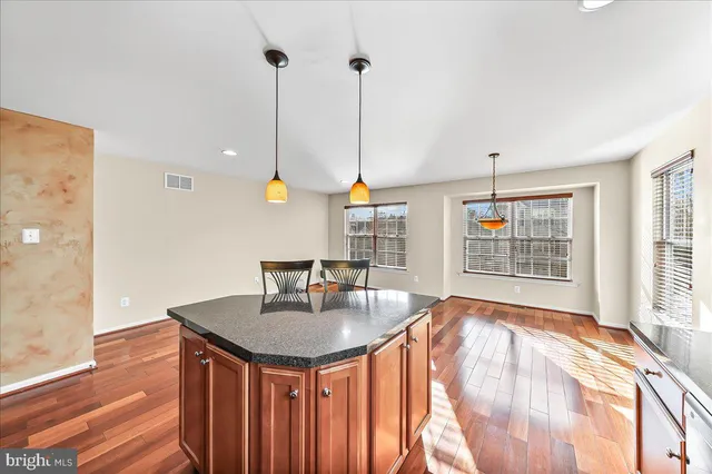 a dining room with table chairs and chandelier fan