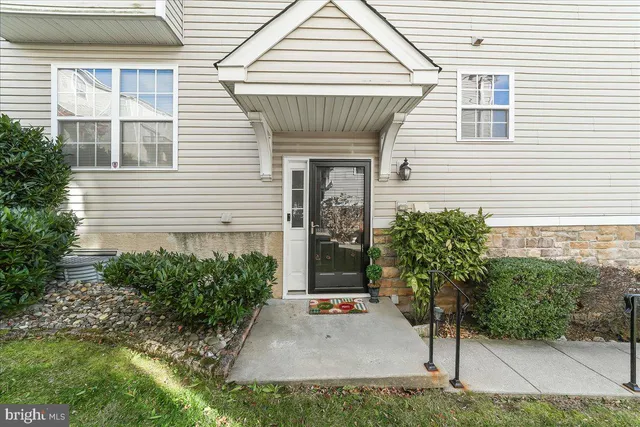 a view of a house with potted plants