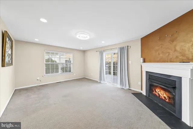 a view of an empty room with a fireplace