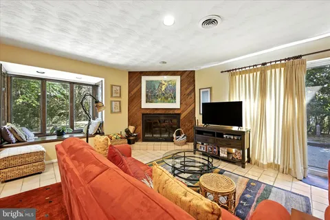 a living room with fireplace furniture and a flat screen tv