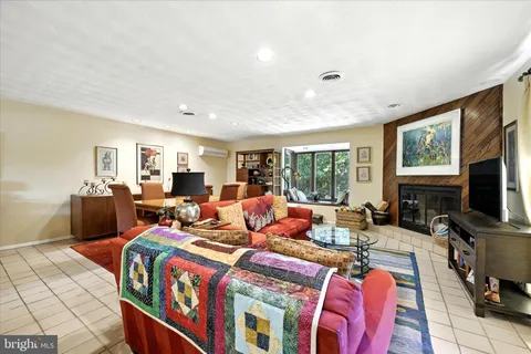 a living room with furniture a flat screen tv and a large window