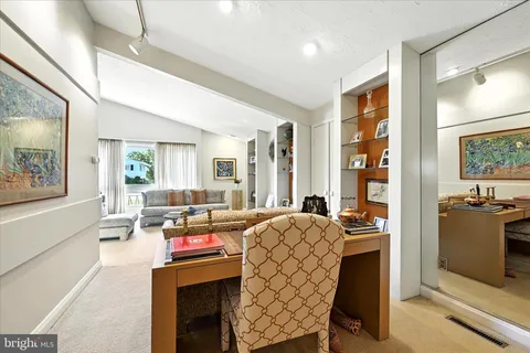 a living room with fireplace furniture and a large window