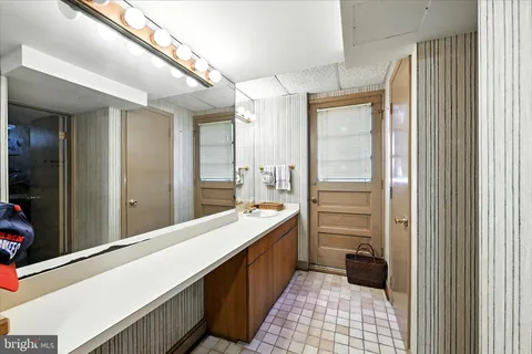 a bathroom with a double vanity sink and a mirror