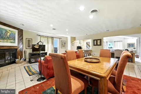 a dining room with furniture and wooden floor