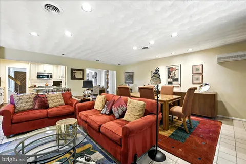 a living room with furniture a rug and a window