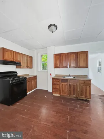 a kitchen with stainless steel appliances a stove a sink and a refrigerator