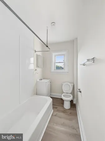 a bathroom with a toilet a sink and shower