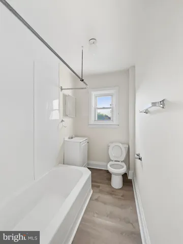 a bathroom with a toilet a sink and shower