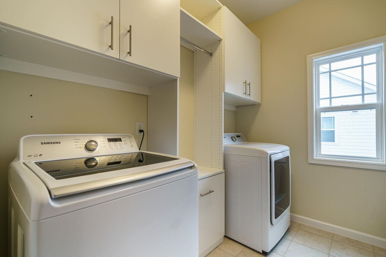 5602 Wade Park Boulevard Raleigh, NC 27607 - Photo 30 of 34 Laundry room with natural lighting, washer and dryer included and custom built in cabinetry along with cabinet for pull out clothes hamper. Laundry Room