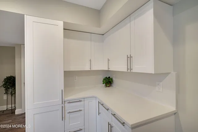 a view of kitchen with white cabinets