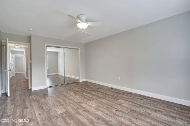 a view of an empty room and wooden floor