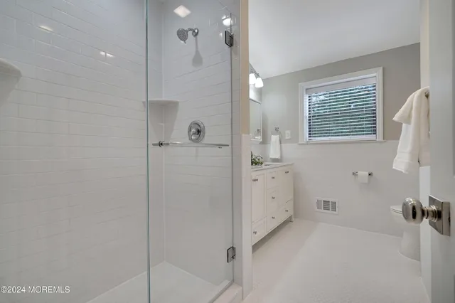 a bathroom with a bathtub sink mirror and shower