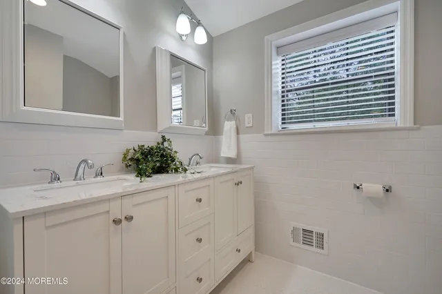 a bathroom with a sink a vanity and a mirror