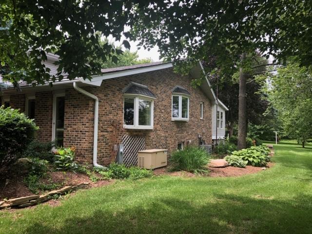 12340 West Offner Road Manhattan, IL 60442 - Photo 2 of 38 a backyard of a house with plants and large tree