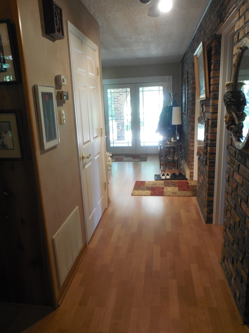 12340 West Offner Road Manhattan, IL 60442 - Photo 15 of 38 a view of empty room with windows and way to kitchen
