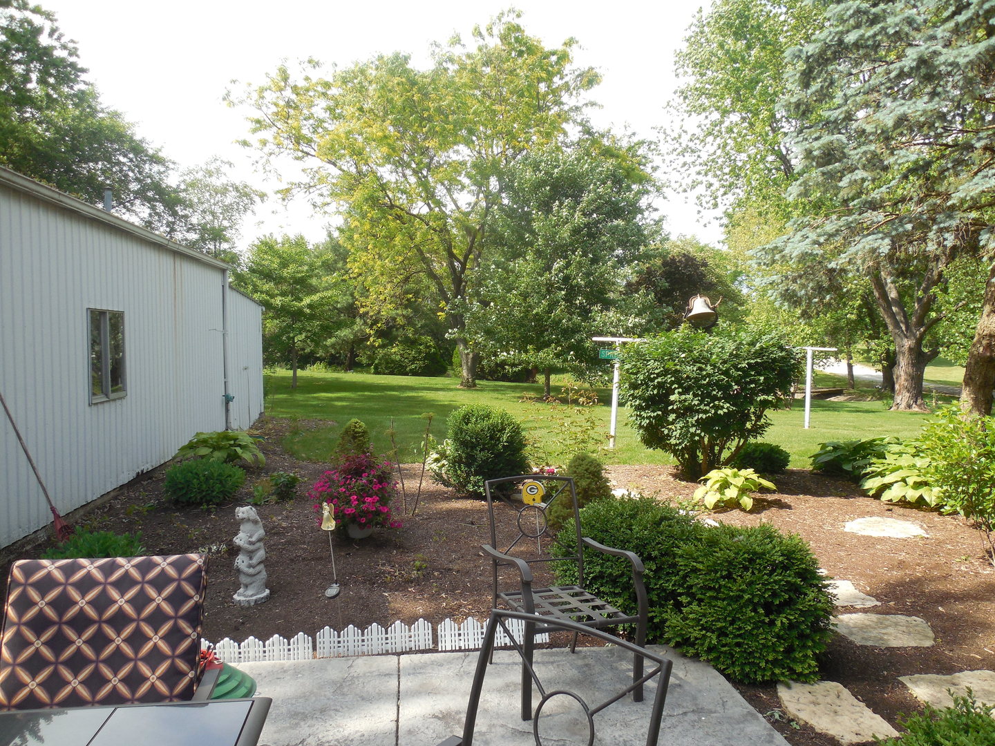 12340 West Offner Road Manhattan, IL 60442 - Photo 32 of 38 a view of a lake with a bench and a yard