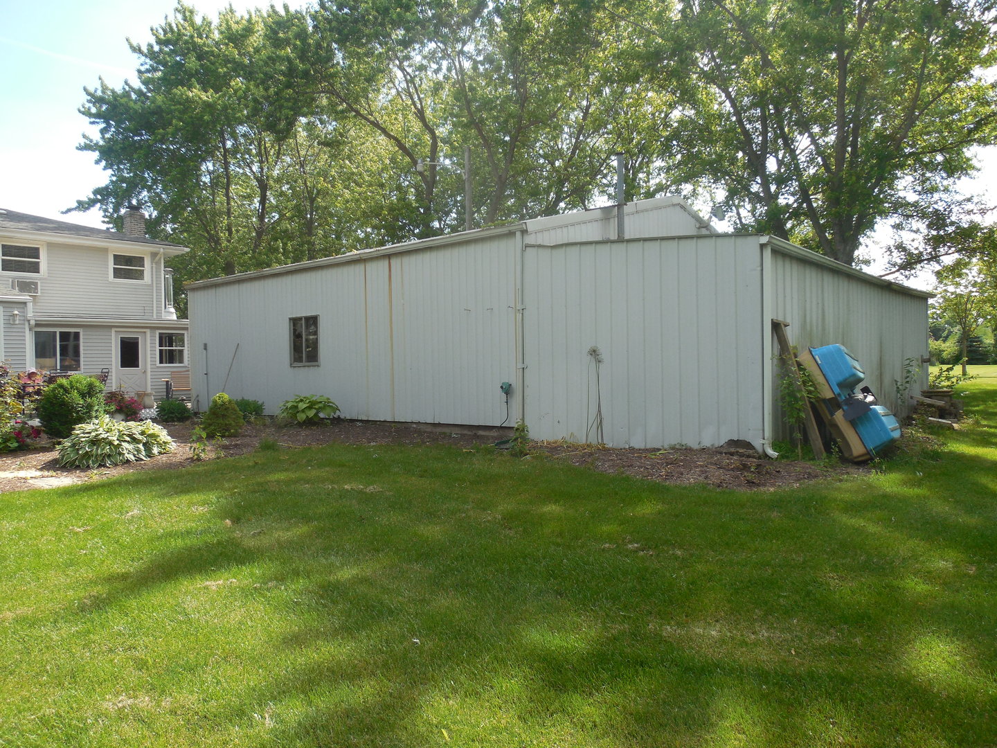 12340 West Offner Road Manhattan, IL 60442 - Photo 38 of 38 a view of a backyard with potted plants and large tree