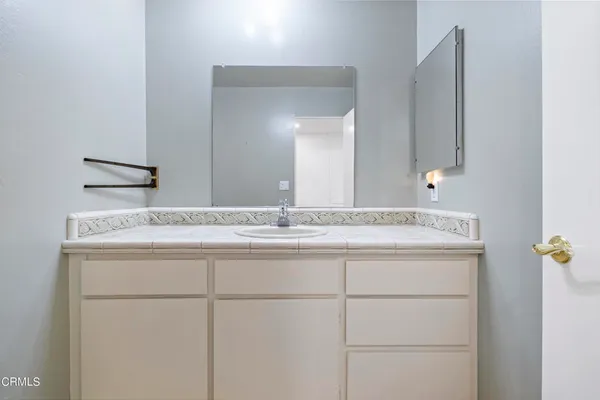 a kitchen with granite countertop a stove top oven sink and cabinets