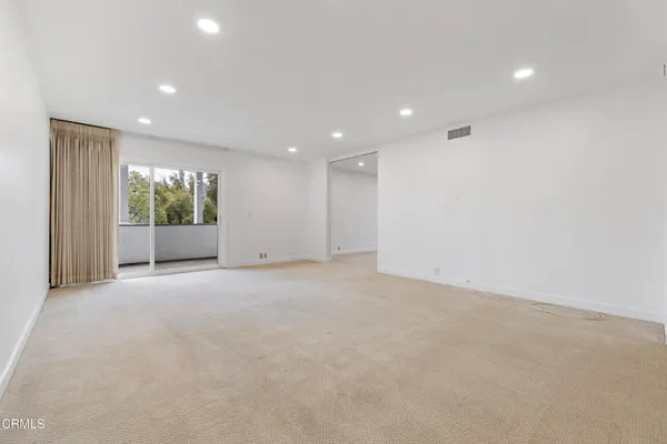 a view of an empty room with a window